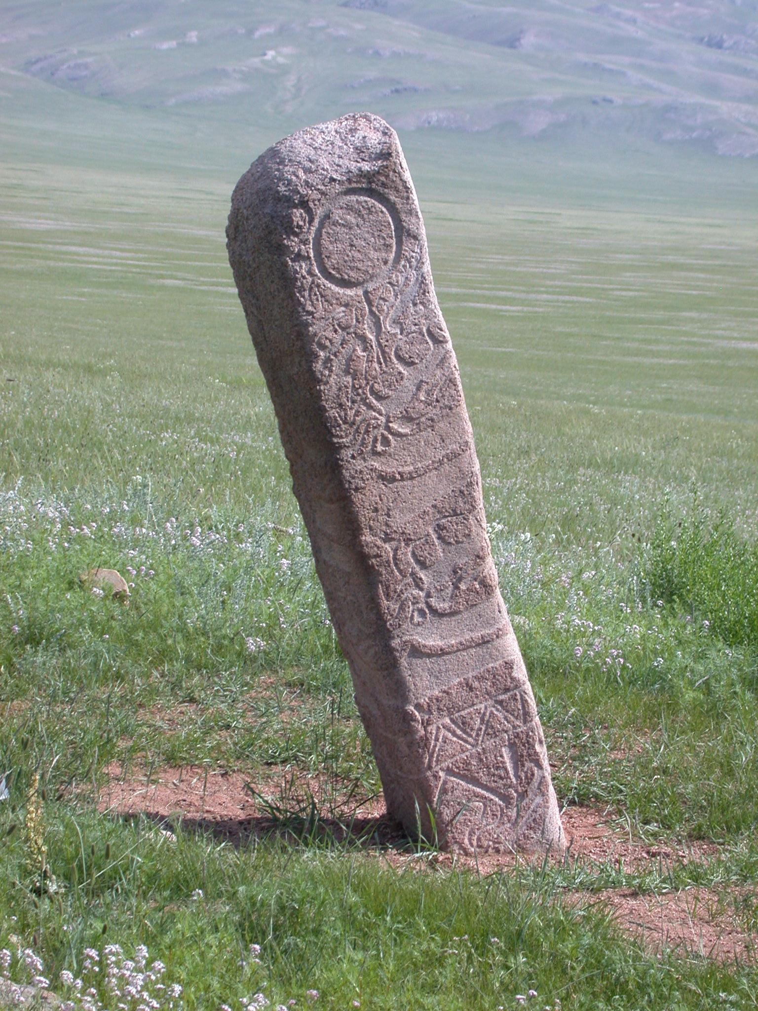 Deer Stone 5 illustrates a ‘Classic Mongolian’ anthropometric deer stone with its ear-ring, encircling deer-bird figures on the torso, and warrior’s belt with hanging weapons. Later this site was heavily damaged by looters. Photo credit: William Fitzhugh.