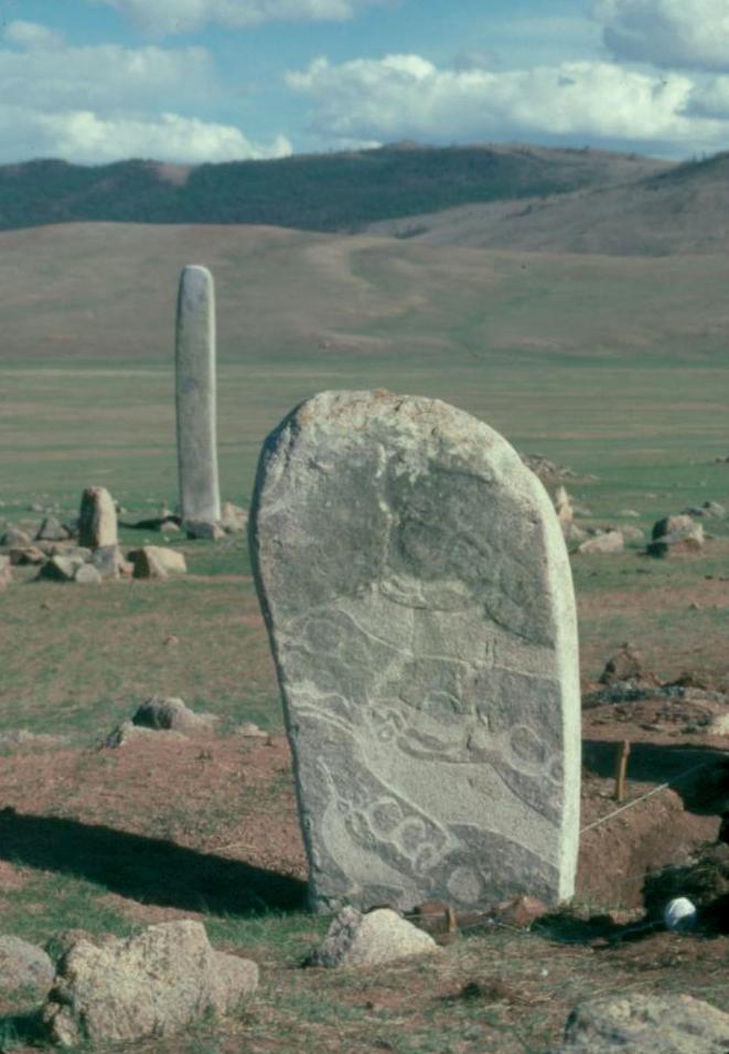 Ulaan Tolgoi Deer Stone 4 shows the iconic transformation image of a leaping or flying stag with scrolling antlers but with the head of a long-billed bird. Excavations around it revealed sacrificial horse head burials. Photo credit: William Fitzhugh.