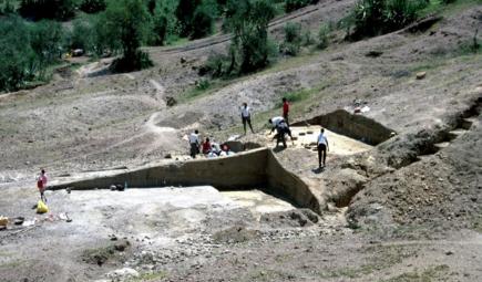 People working on a dry hillside.
