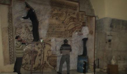 Syrians apply glue to mural wall for protection