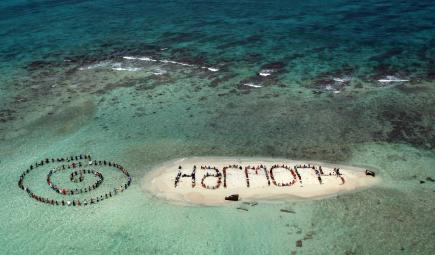 Reef conservation team members spelling out Harmony as sign of hope