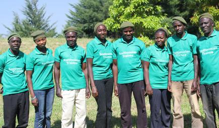 Trainees from local community pose near forest plot