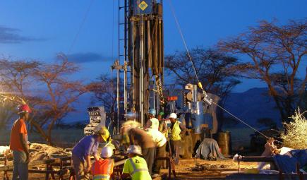 Crew working at drilling site at nighttime