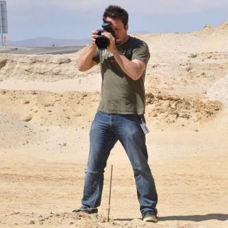 Photographer taking photos of fossils in desert