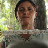 Taino healer spinning cotton from her garden