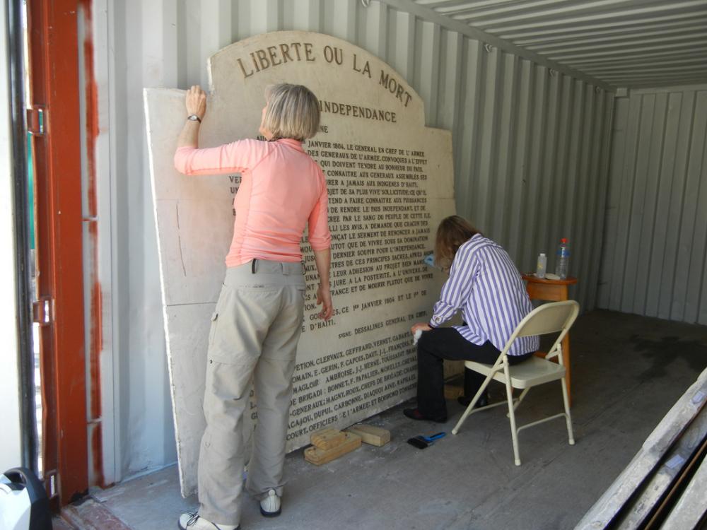 Smithsonian conservators Helen Ingalls (SAAM, left) and Carol Grissom (MCI, right) clean and stabilize L'Acte d'Independance. Photo credit Stephanie Hornbeck.