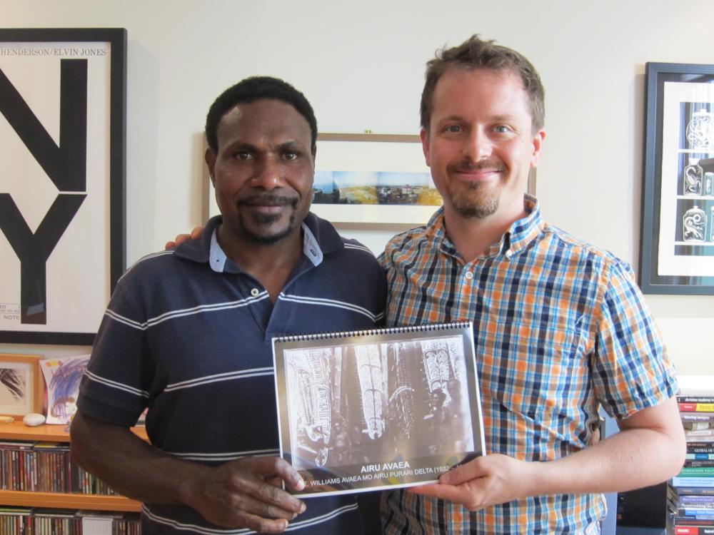 Joshua A. Bell and Keneva Henry Ke'a with the reprint of F.E. William's 1922 monograph about the Purari Delta, which they translated into I'ai for the community's use. Photo Credit Joshua A. Bell