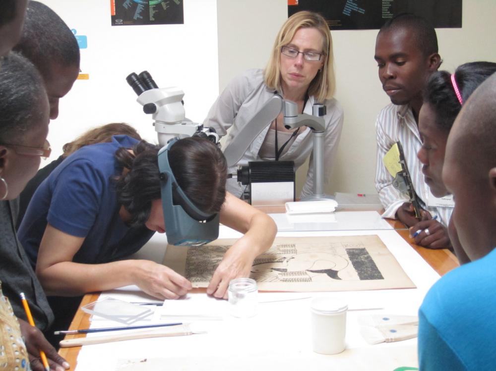 Smithsonian conservators Emily Jacobsen (FSG, left) and Rosemary Fallon (NPG, center) teach a workshop on basic paper stabilization methods. Photo credit Stephanie Hornbeck.