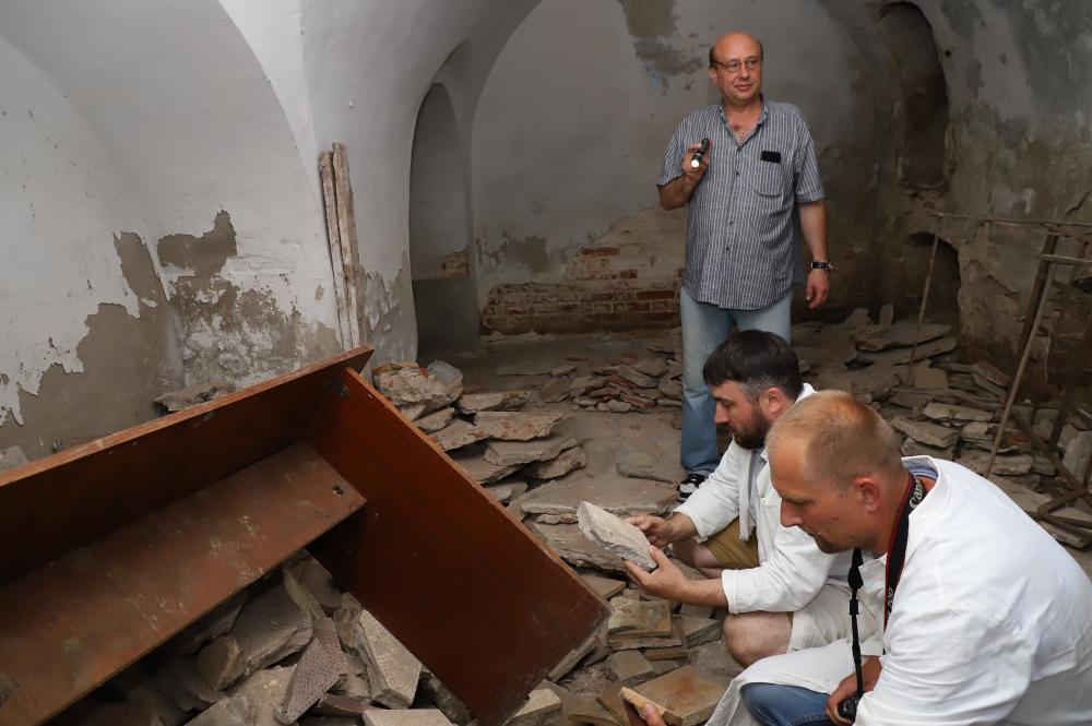 NRRC conservators assessing damage on the ground at a cultural center.