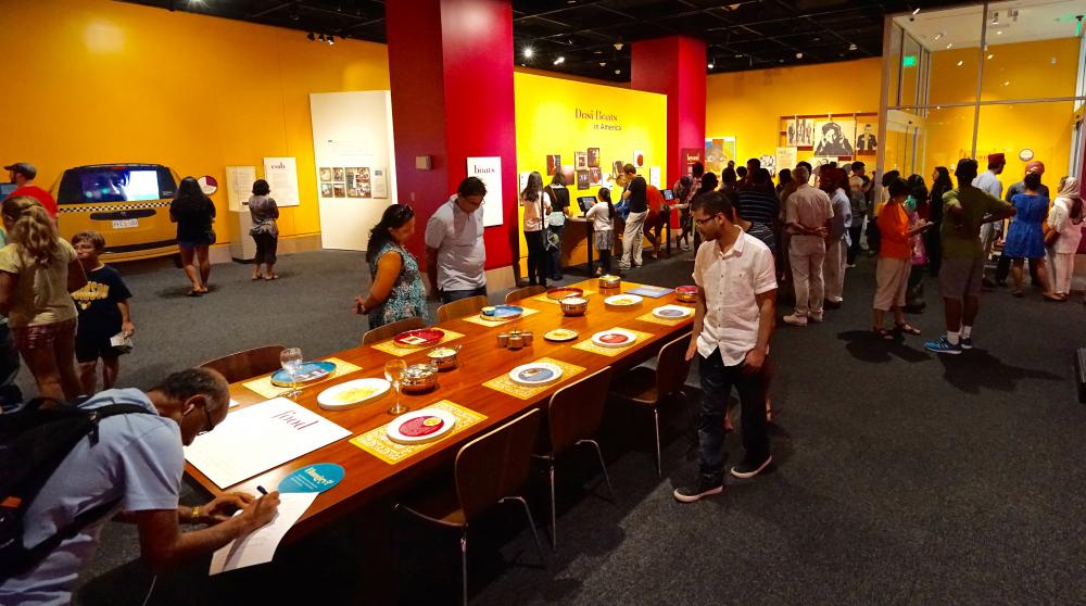 Visitors in the "Beyond Bollywood" exhibition at the National Museum of Natural History, August 2015. Photograph by Shan Jalla. Courtesy: Smithsonian Asian Pacific American Center	