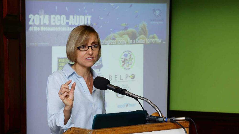 During the launch of the 2014 Eco-Audit in Belize City, Melanie indicates the small amount of progress measured in that evaluation. Credit: Alexander Ellis / Oceana.