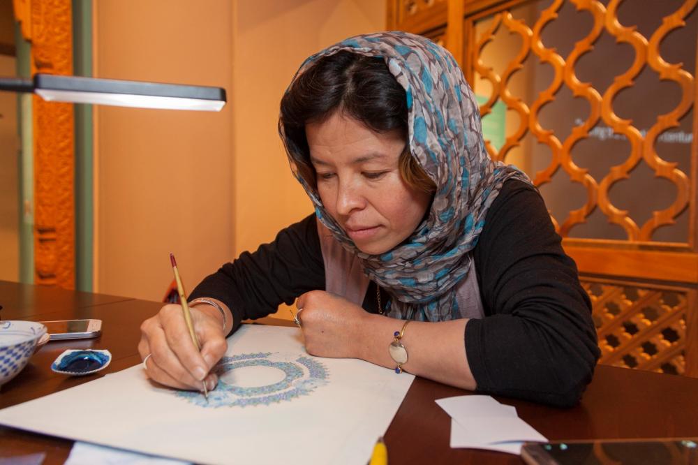 Artist at work in the exhibition.