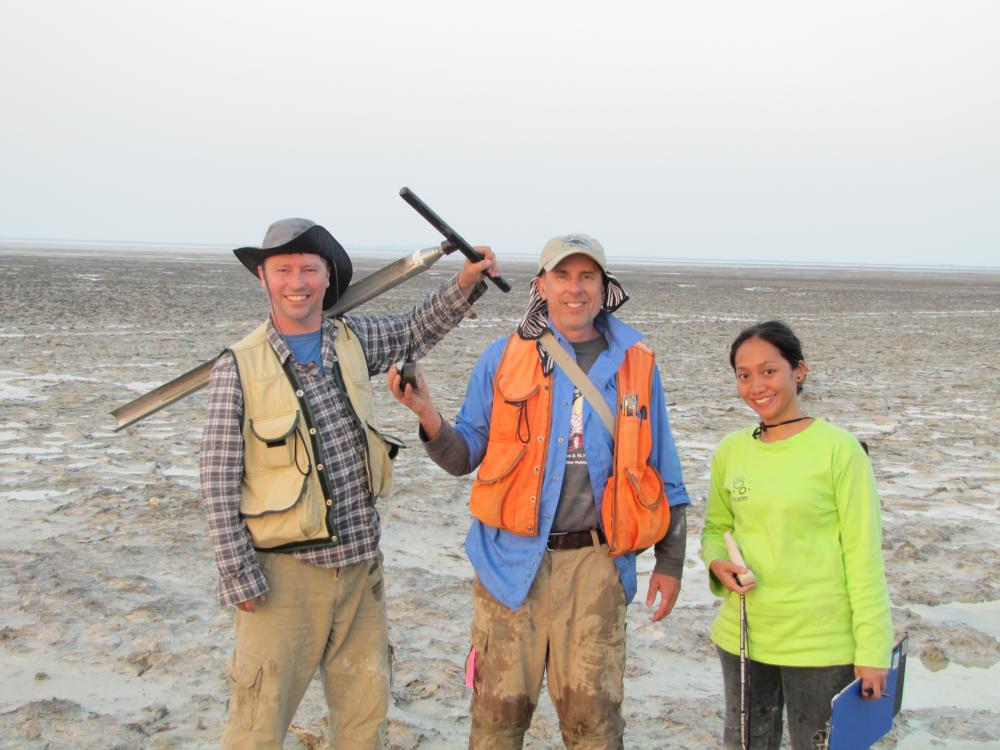 Pat Megonigal (center) with members of his team in Abu Dhabi. Photo credit Boone Kauffman.	